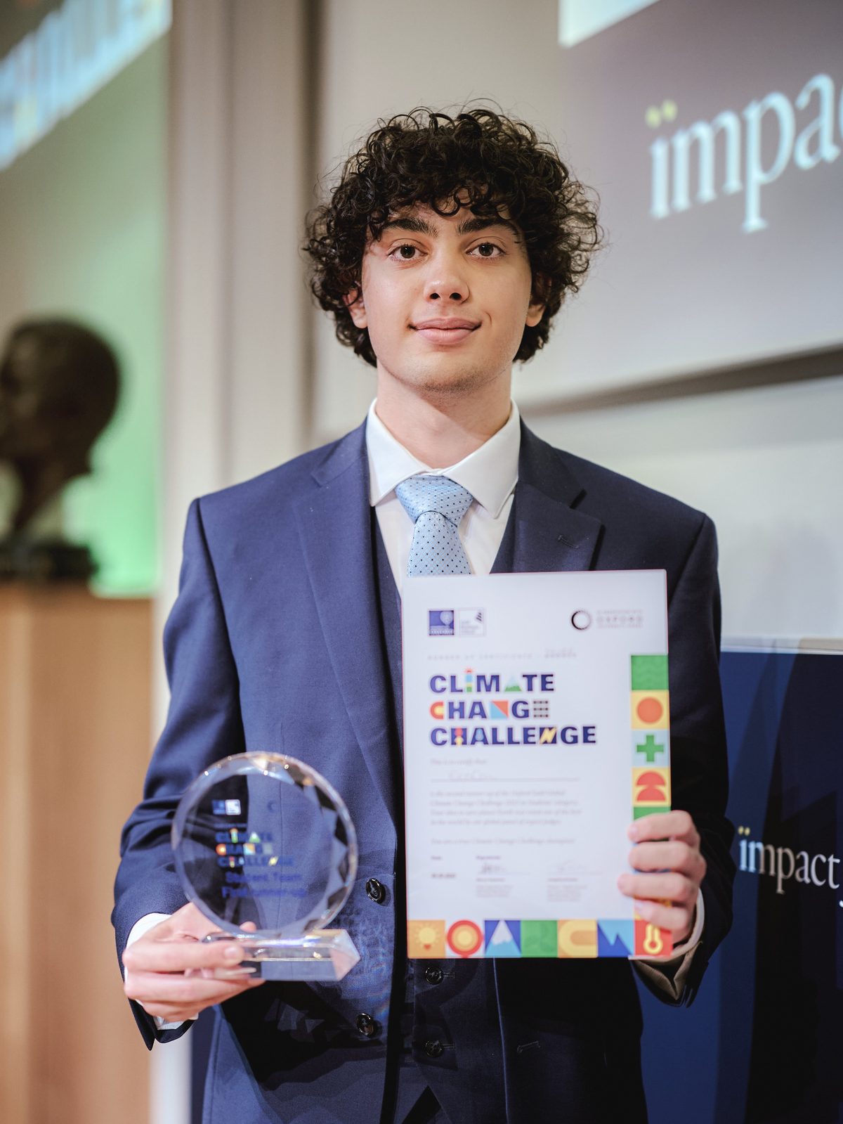 Cyrus holding the Oxford Global Climate Challenge trophy